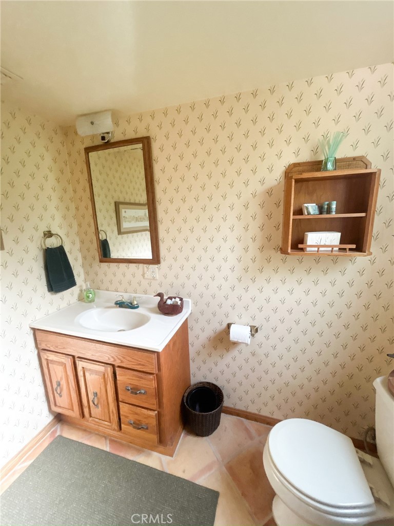 2153 Florence Boulevard Blythe, CA 92225 - Photo 16 of 38 a bathroom with a toilet a sink and mirror