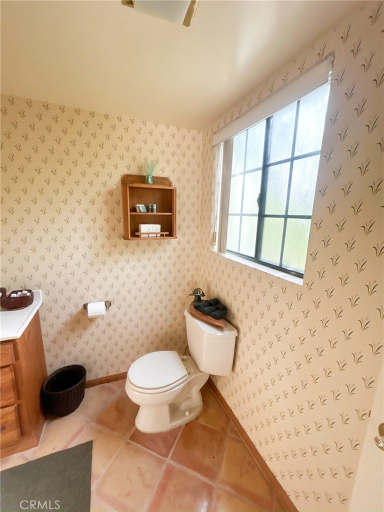 2153 Florence Boulevard Blythe, CA 92225 - Photo 17 of 38 a bathroom with a toilet a sink and a mirror