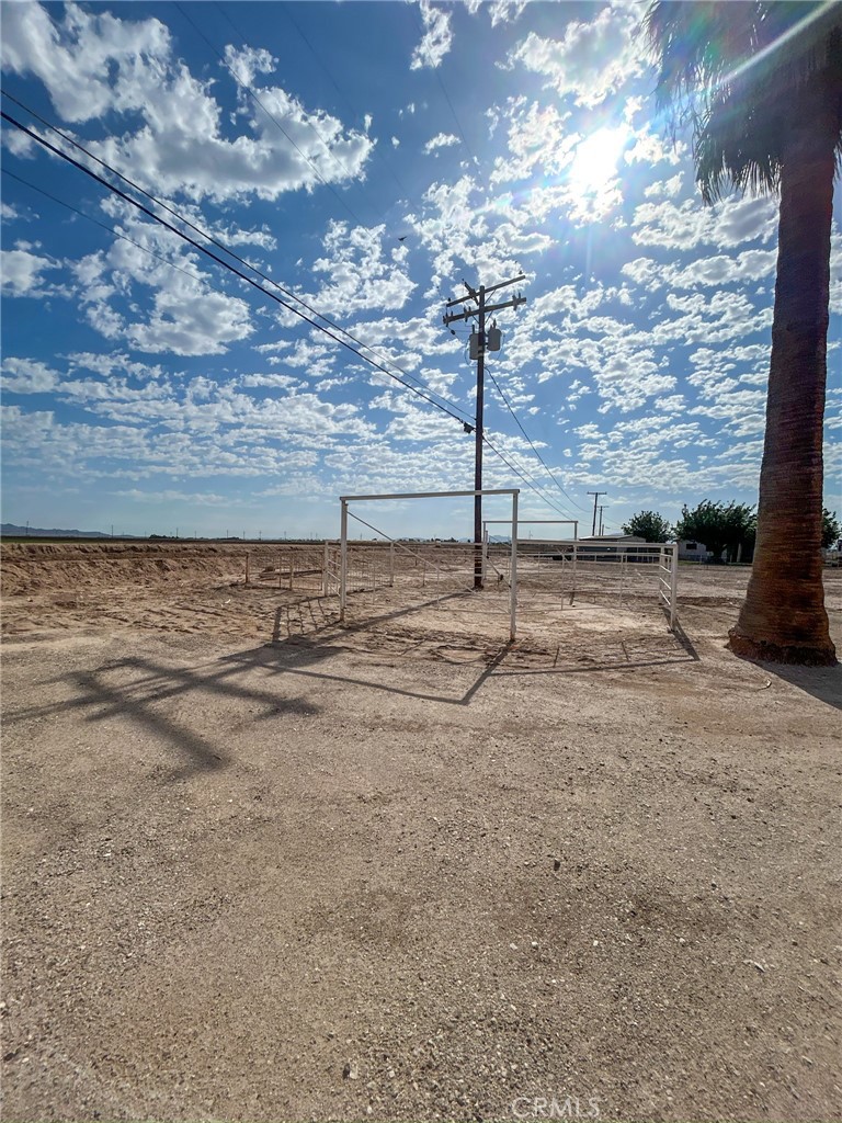 2153 Florence Boulevard Blythe, CA 92225 - Photo 31 of 38 a view of a dry yard with wooden fence
