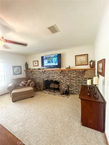 a spacious bedroom with a bed and ceiling fan