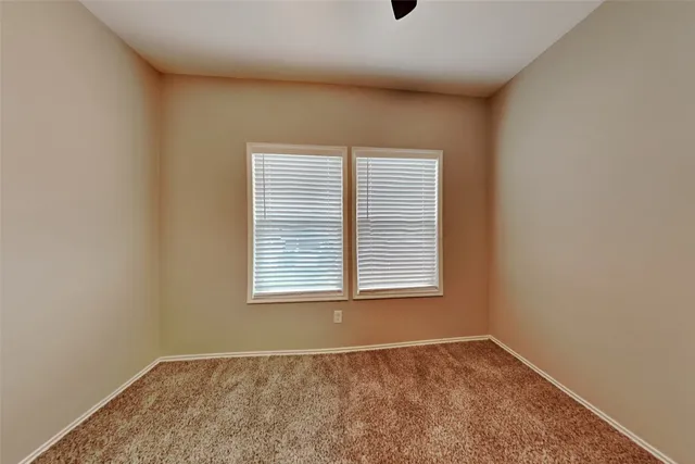 a bathroom with a toilet and shower