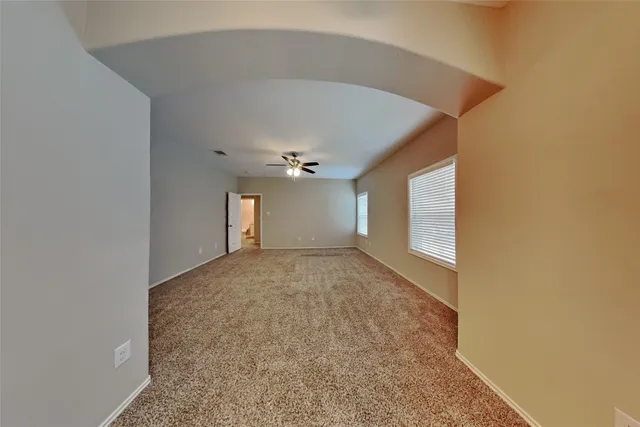a view of a big room with closet and windows