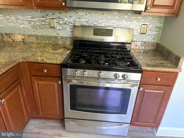 a stove top oven sitting inside of a kitchen