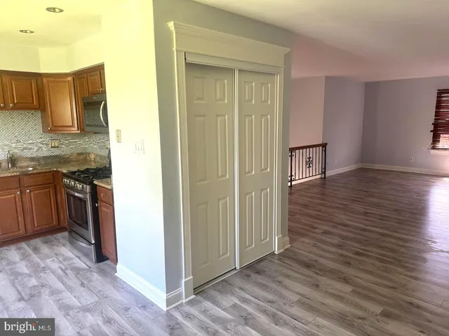 a view of a kitchen from the hallway with a sink