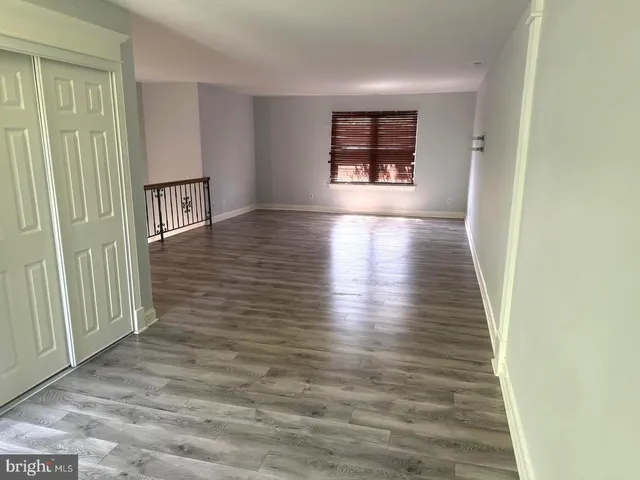 wooden floor in a hall with an empty room