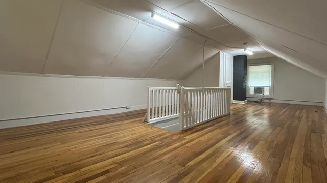 a view of a room with wooden floor