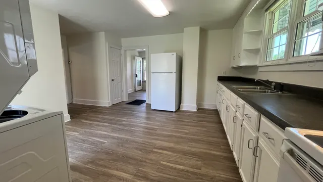 a kitchen with granite countertop a refrigerator and a stove