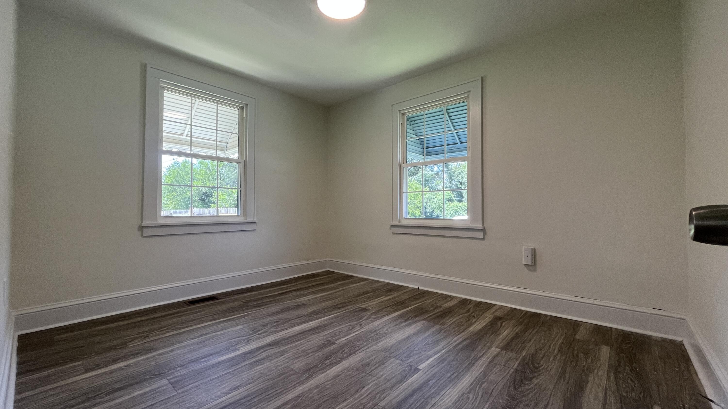 4042 Tennessee Avenue Northwest Roanoke, VA 24017 - Photo 14 of 17 a view of a room with wooden floor and windows in it