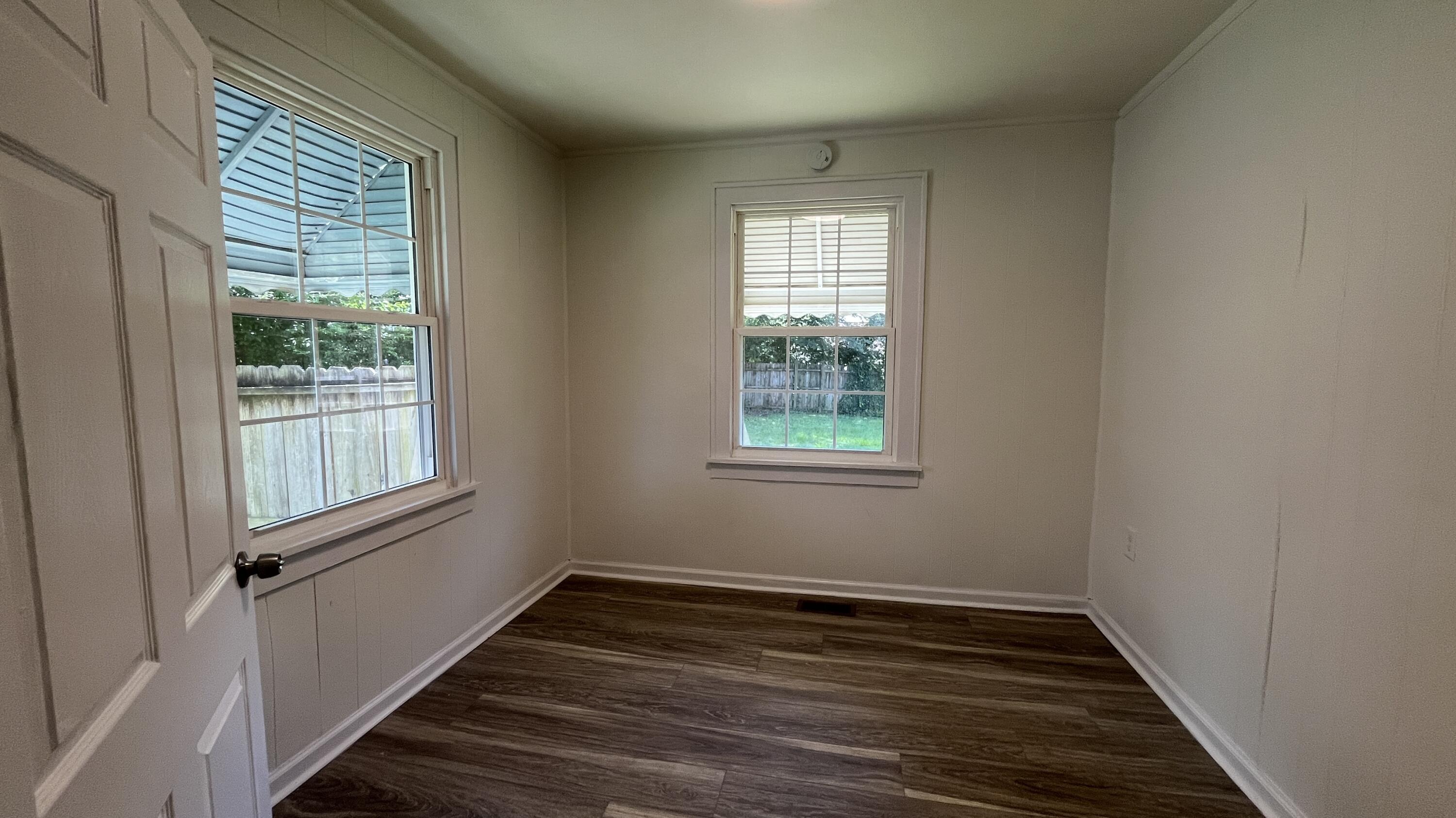 4042 Tennessee Avenue Northwest Roanoke, VA 24017 - Photo 3 of 17 a view of an empty room with wooden floor and a window