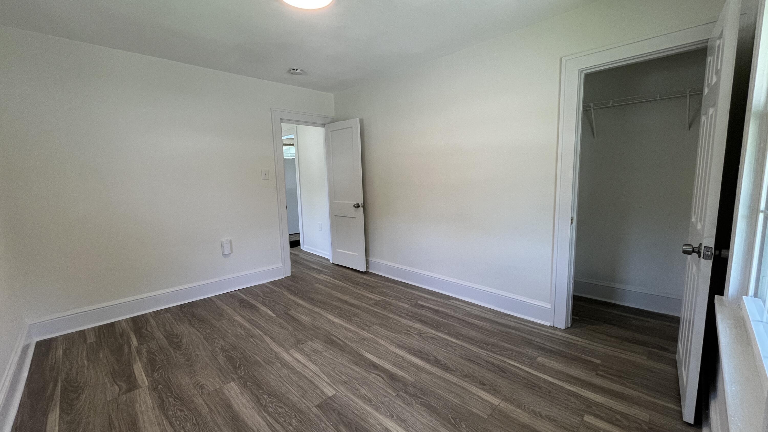 4042 Tennessee Avenue Northwest Roanoke, VA 24017 - Photo 4 of 17 a view of an empty room with wooden floor and a window