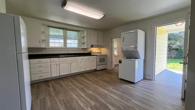a kitchen with a sink a counter top space and cabinets