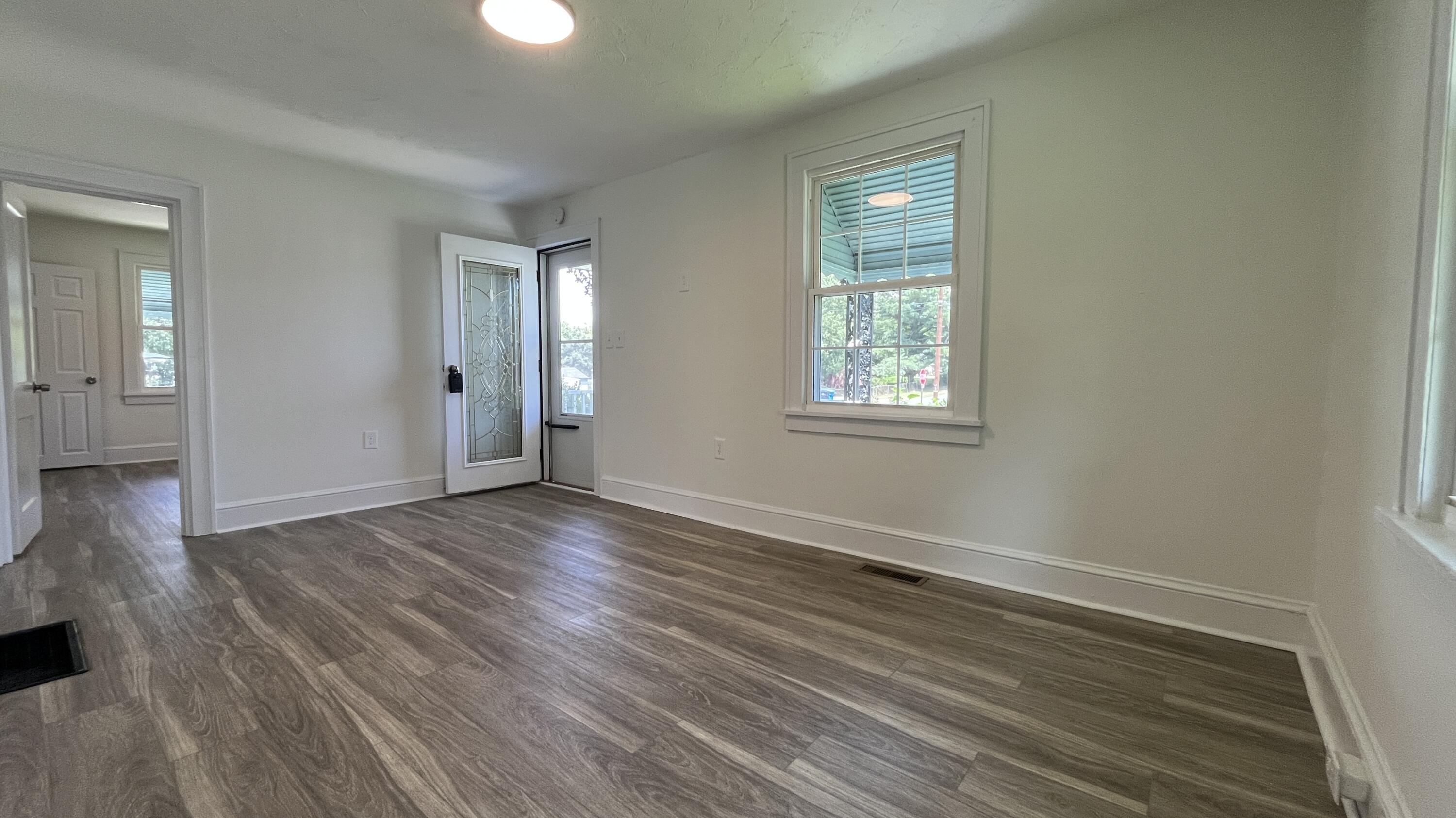 4042 Tennessee Avenue Northwest Roanoke, VA 24017 - Photo 10 of 17 a view of an empty room with wooden floor and a window