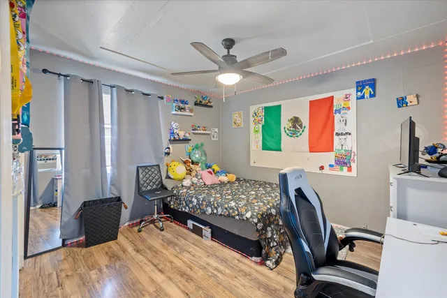 a bed room with a bed mirror and a window