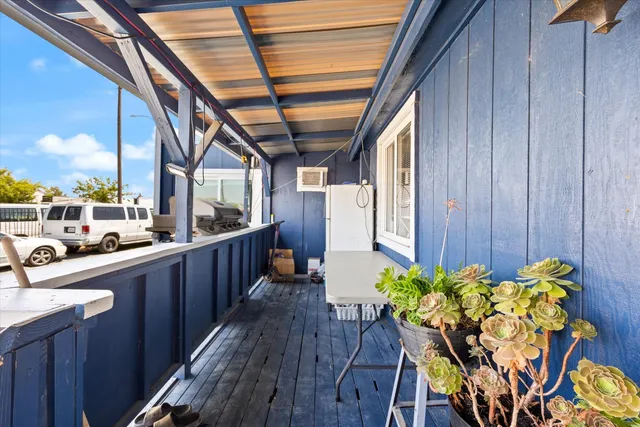 a dining room with furniture a potted plant and wooden floor