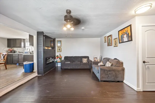 a living room with furniture and kitchen view