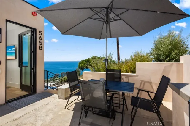 a view of a patio with furniture and a umbrella