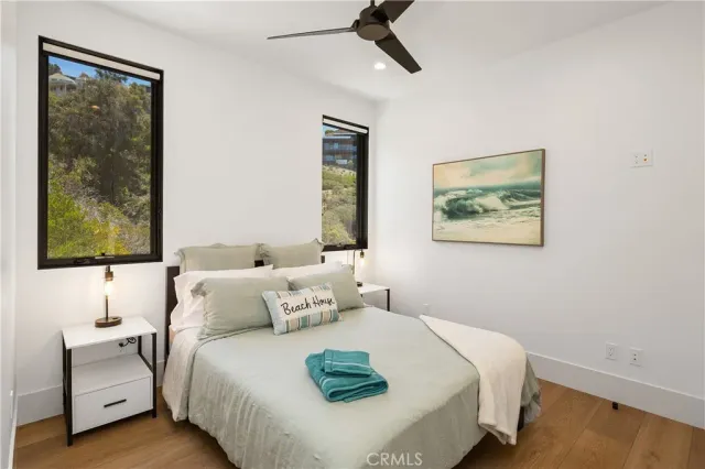 a bedroom with a bed and a painting on the wall