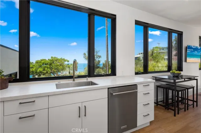 a sink with a large window next to a yard