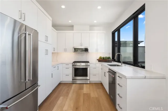 a kitchen with a stove a sink and a refrigerator