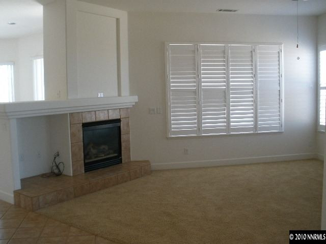 5802 North White Sands Road Reno, NV 89511 - Photo 2 of 9 an empty room with windows and fireplace