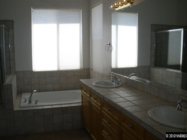 5802 North White Sands Road Reno, NV 89511 - Photo 6 of 9 a bathroom with a sink and a bathtub