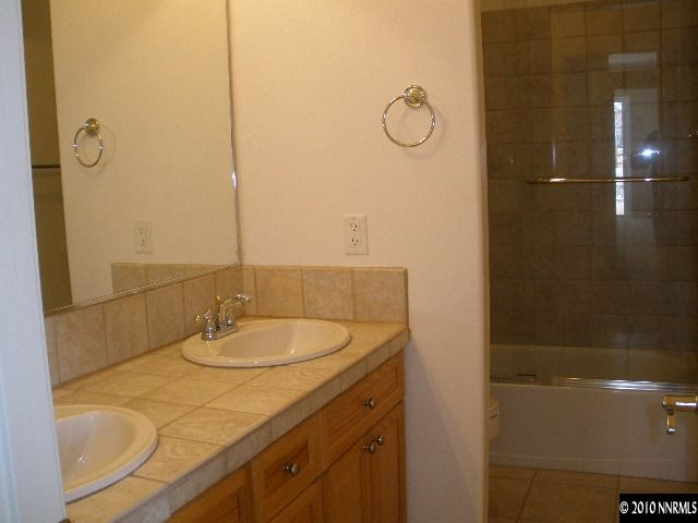 5802 North White Sands Road Reno, NV 89511 - Photo 7 of 9 a bathroom with a sink and shower