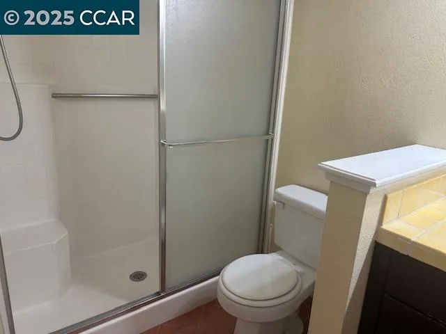 a bathroom with a shower a toilet and sink