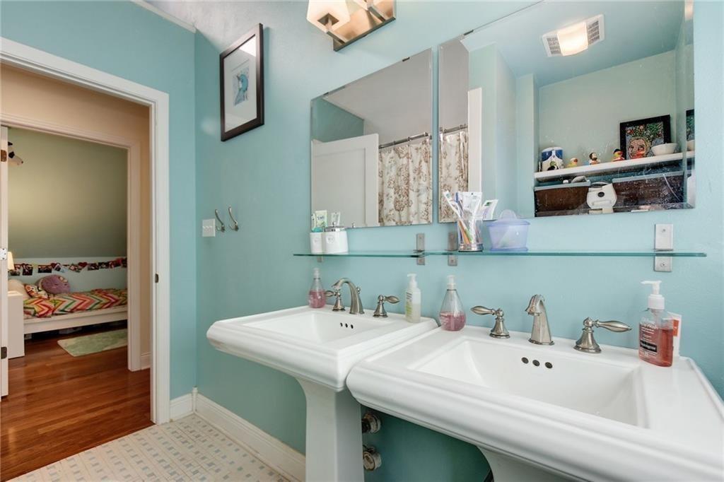 4412 Barrow Avenue, Unit A Austin, TX 78751 - Photo 20 of 28 Ensuite bathroom featuring curtained shower and wood finished floors
