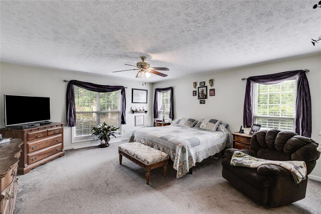 144 Bobs Drive Mableton, GA 30126 - Photo 15 of 33 a spacious bedroom with a bed and a couch