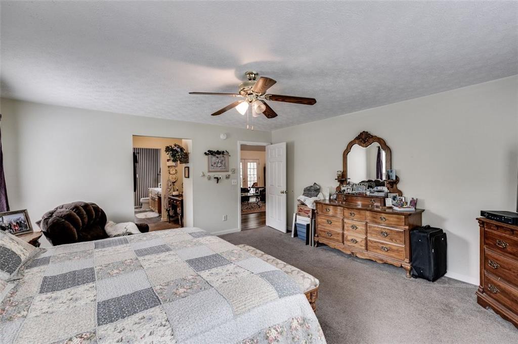 144 Bobs Drive Mableton, GA 30126 - Photo 16 of 33 a bedroom with furniture a bed and a chandelier