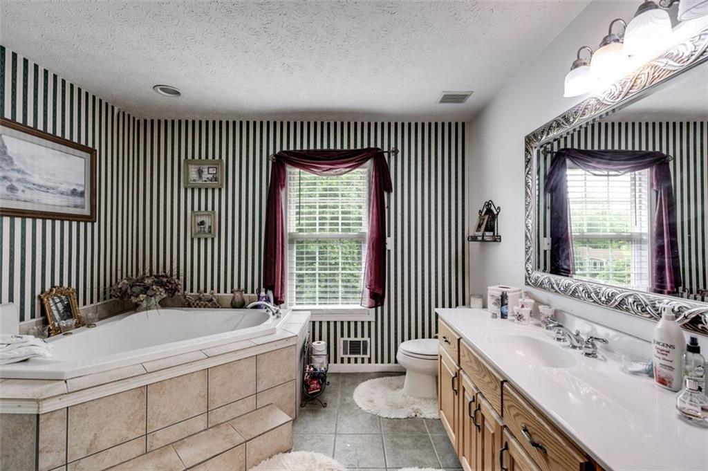 144 Bobs Drive Mableton, GA 30126 - Photo 17 of 33 a spacious bathroom with a tub sink and mirror