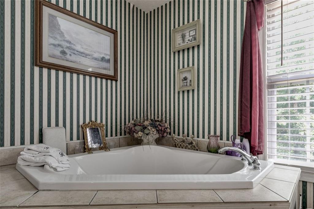 144 Bobs Drive Mableton, GA 30126 - Photo 19 of 33 a bath tub sitting in a bathroom next to a window