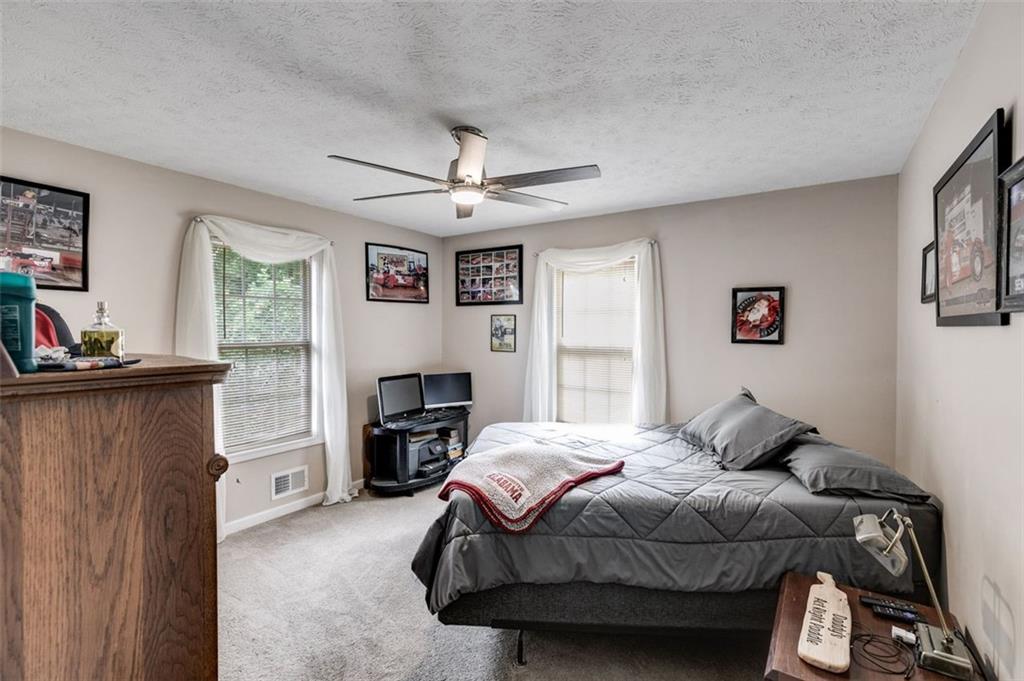 144 Bobs Drive Mableton, GA 30126 - Photo 20 of 33 a bedroom with a bed and a chandelier