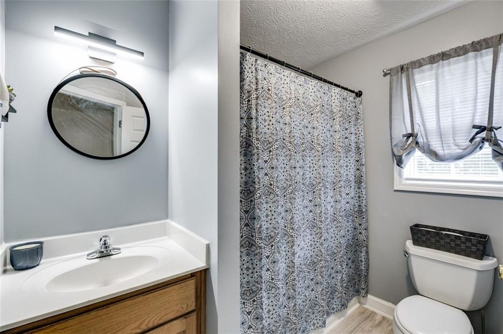 144 Bobs Drive Mableton, GA 30126 - Photo 21 of 33 a bathroom with a granite countertop toilet sink and mirror