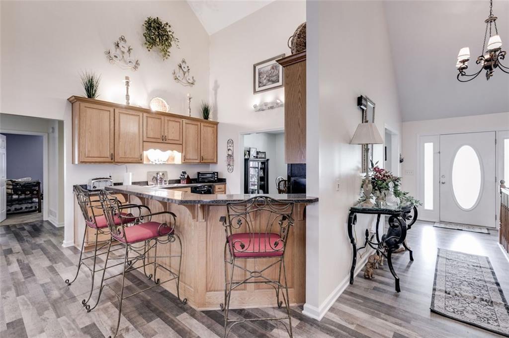 144 Bobs Drive Mableton, GA 30126 - Photo 6 of 33 a open kitchen with stainless steel appliances granite countertop a stove top oven a sink and cabinets
