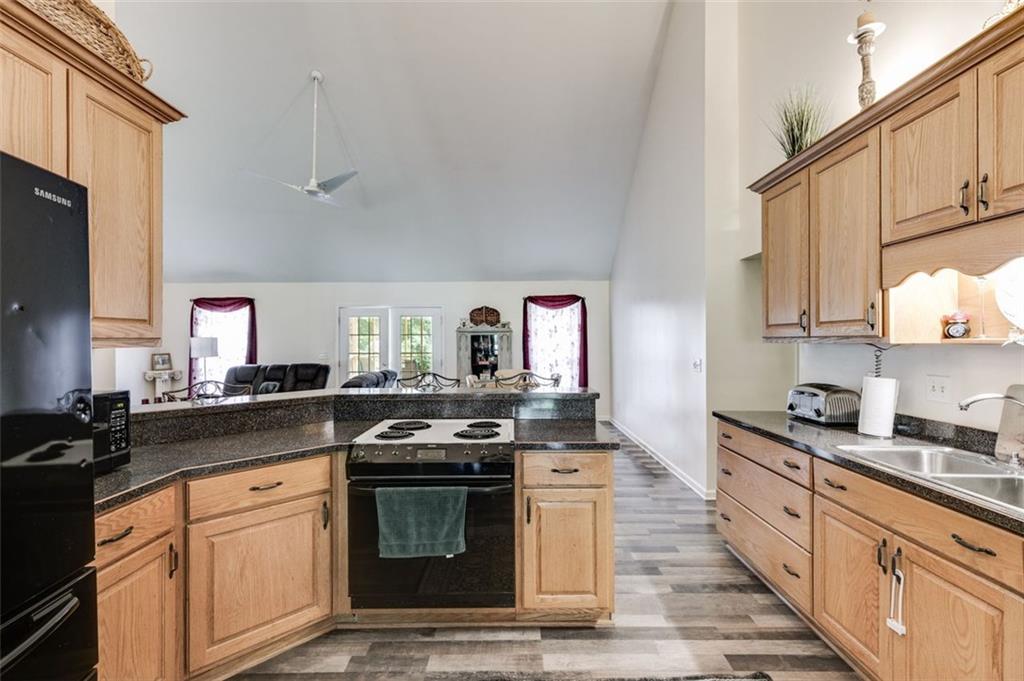 144 Bobs Drive Mableton, GA 30126 - Photo 7 of 33 a kitchen with stainless steel appliances a stove a sink dishwasher and cabinets with wooden floor