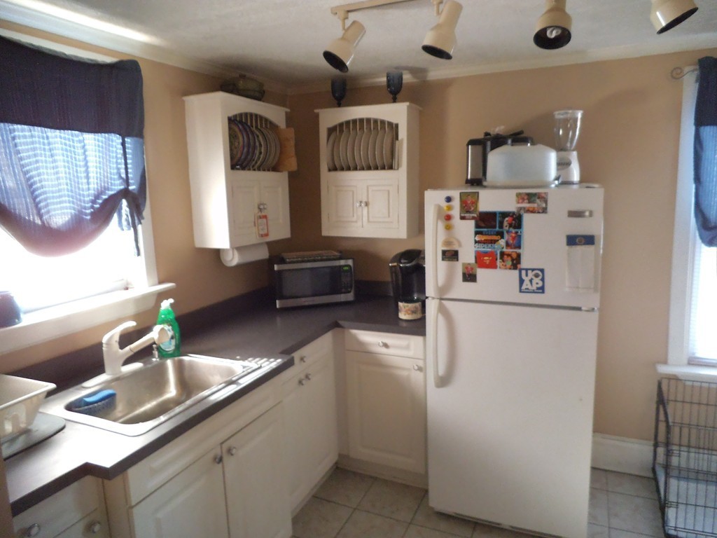 149 Franklin Street Fall River, MA 02720 - Photo 7 of 14 a kitchen with a refrigerator and a sink