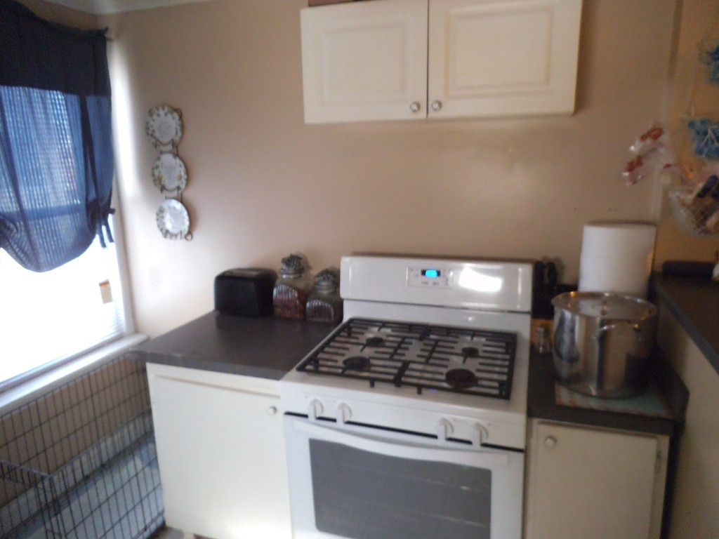 149 Franklin Street Fall River, MA 02720 - Photo 8 of 14 a stove top oven sitting inside of a kitchen