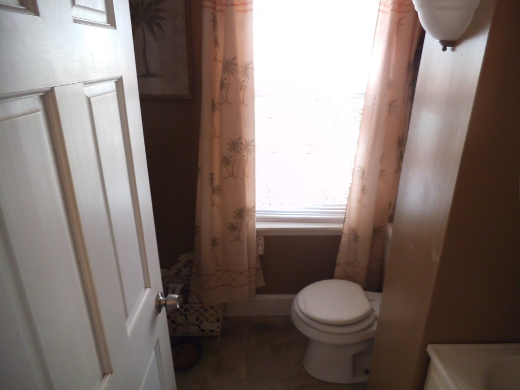 149 Franklin Street Fall River, MA 02720 - Photo 9 of 14 a white toilet sitting next to a window