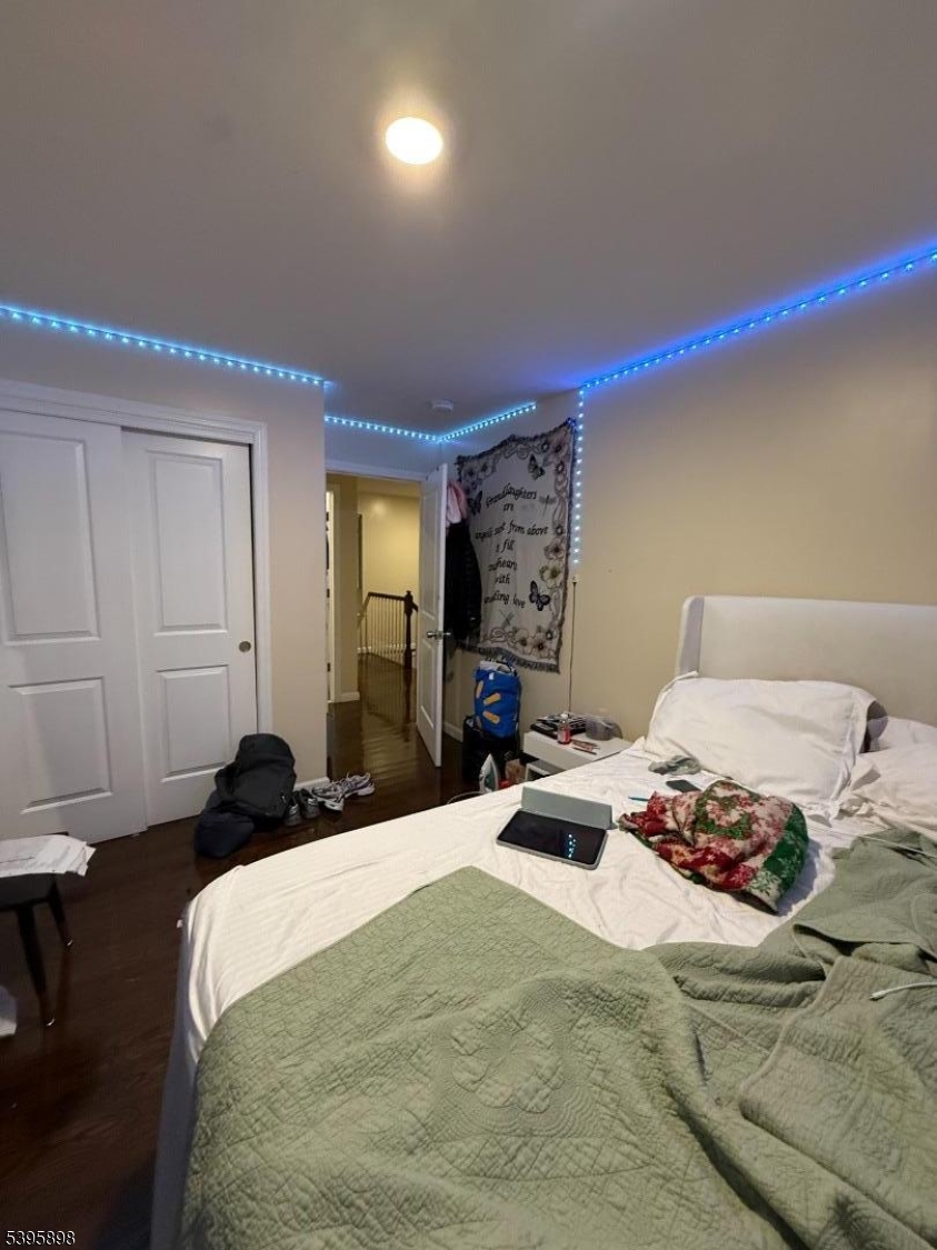 575 Hawthorne Avenue Newark, NJ 07112 - Photo 13 of 14 a bedroom with a bed and a large mirror