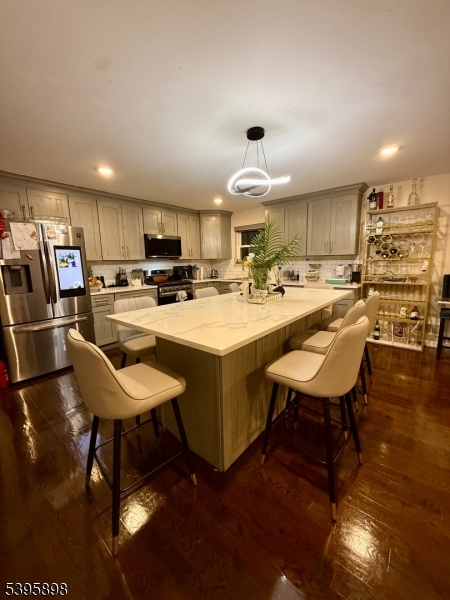 575 Hawthorne Avenue Newark, NJ 07112 - Photo 5 of 14 a kitchen with sink refrigerator and cabinets