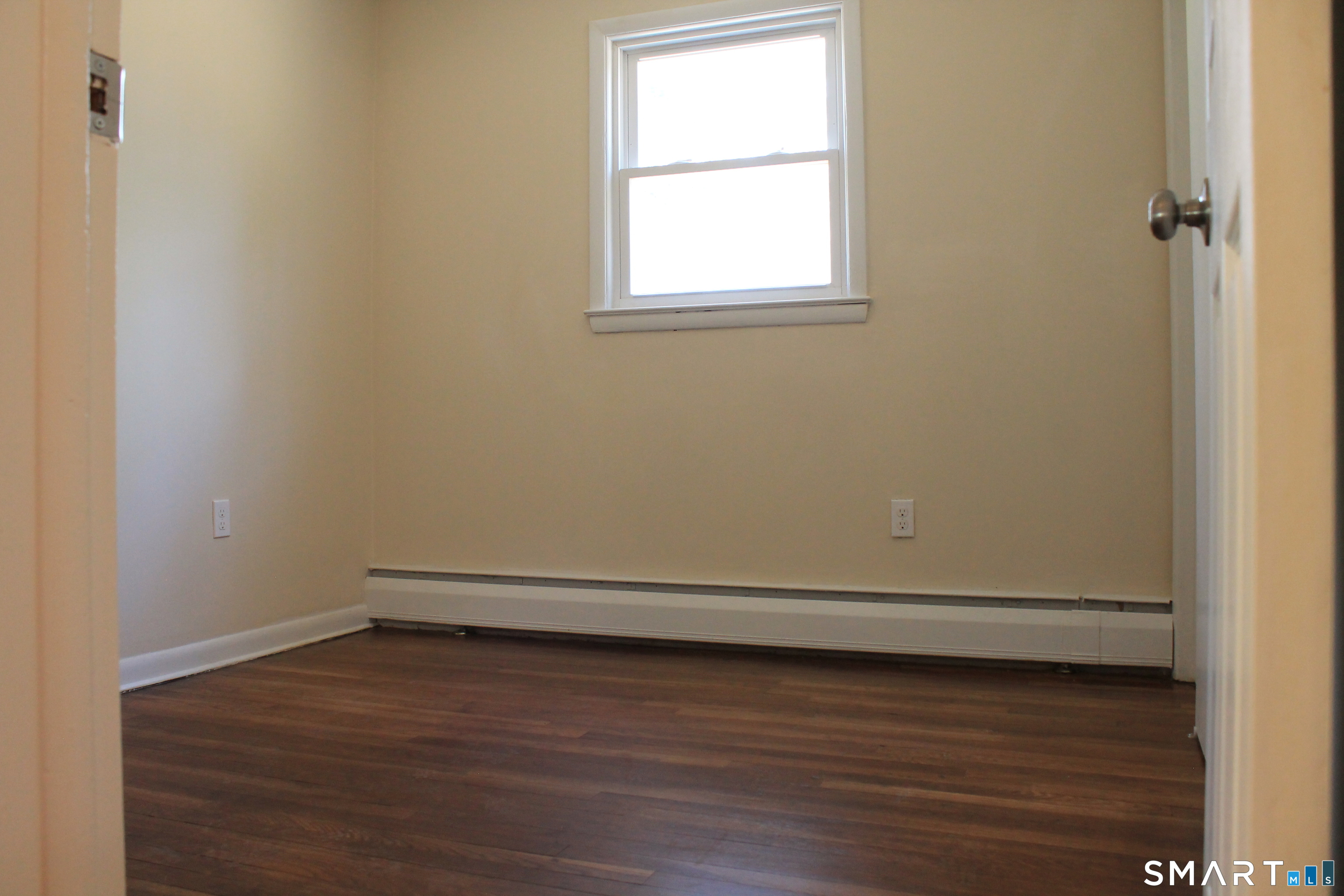 134 Sunset Street Windsor Locks, CT 06096 - Photo 22 of 23 an empty room with wooden floor and window