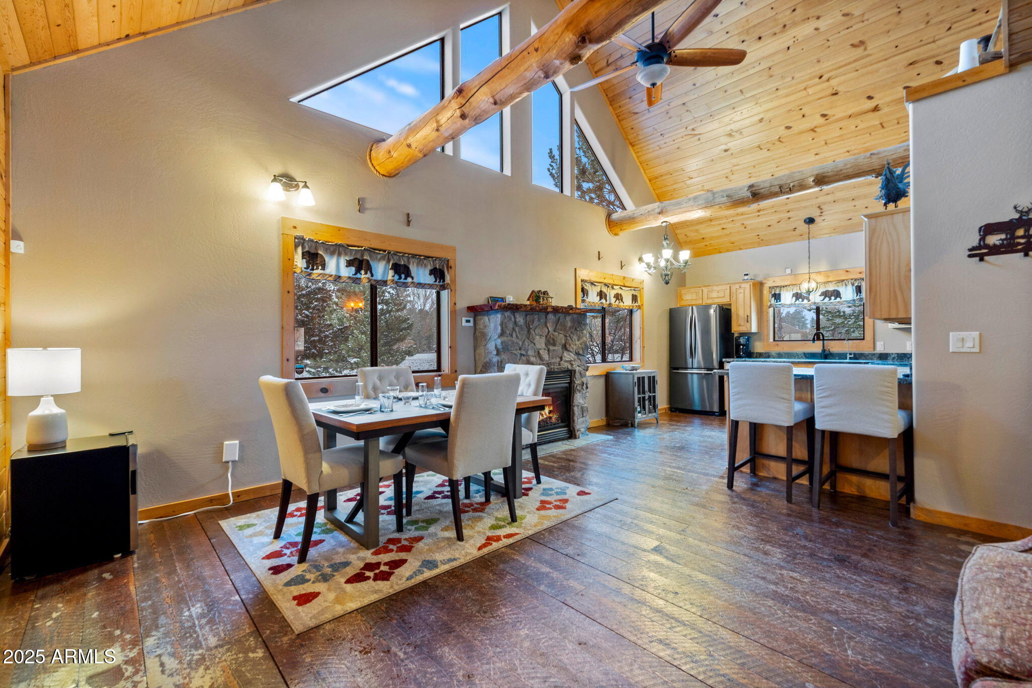 2300 Overgaard Springs Loop Overgaard, AZ 85933 - Photo 16 of 48 a dining room with wooden floor a table and chairs