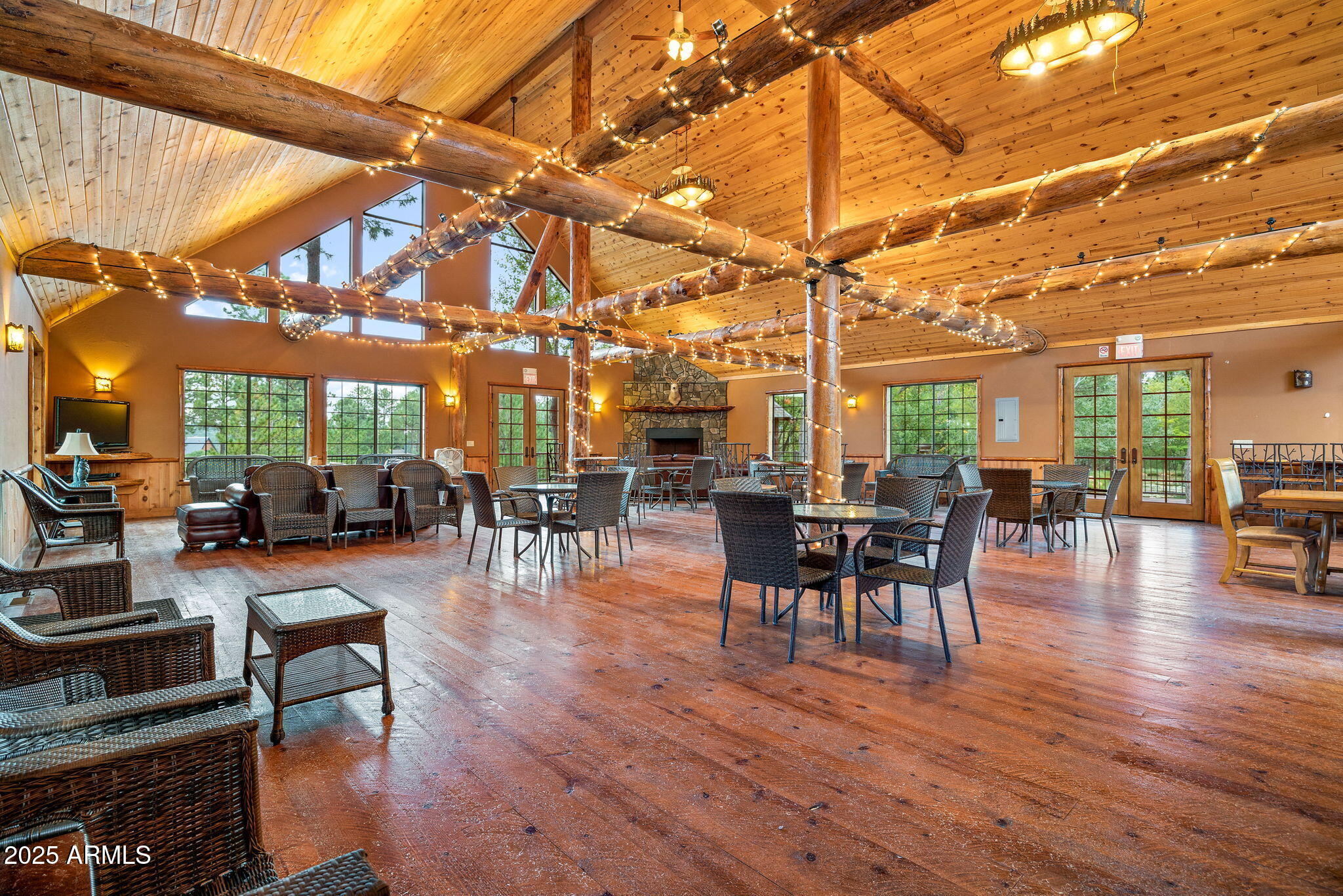 2300 Overgaard Springs Loop Overgaard, AZ 85933 - Photo 40 of 48 a dining room with wooden floor a chandelier a wooden table and chairs