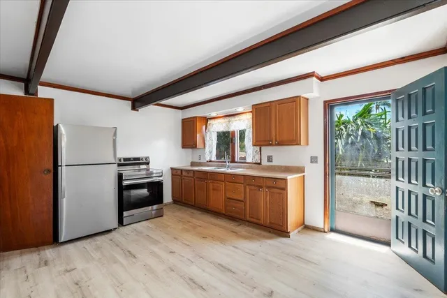 a kitchen with granite countertop a refrigerator and a stove