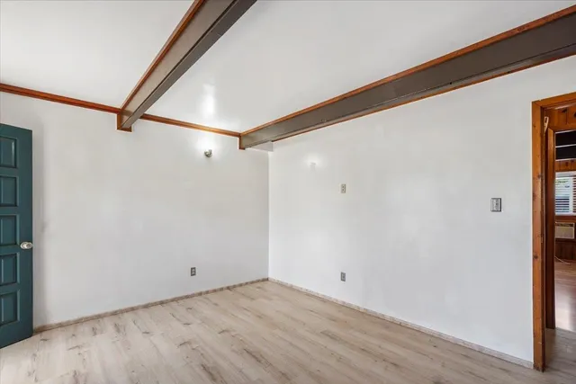 a view of a room with wooden floor