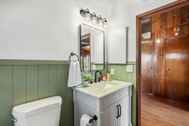 a bathroom with a sink toilet and mirror