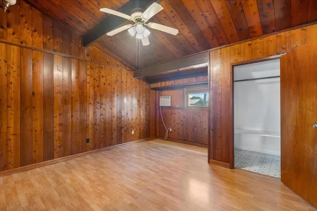 an empty room with fan and entrance