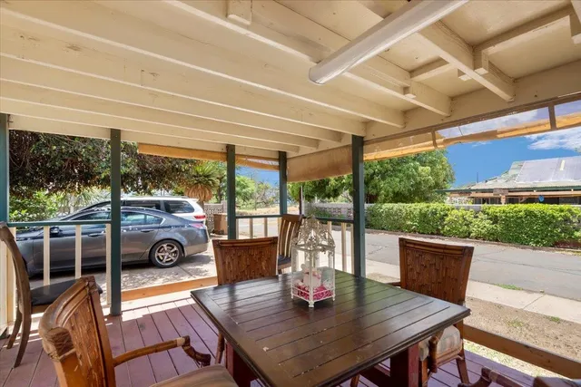 a view of a yard with plants and trees