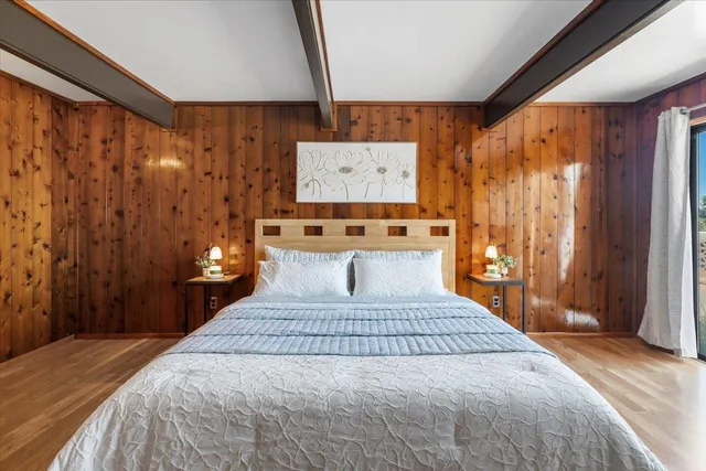 a bedroom with a large bed and a window